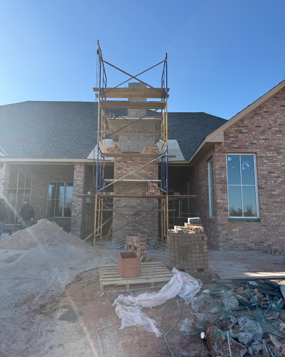 Chimney brickwork progress at Grace on 5 residential project in Edmond Oklahoma