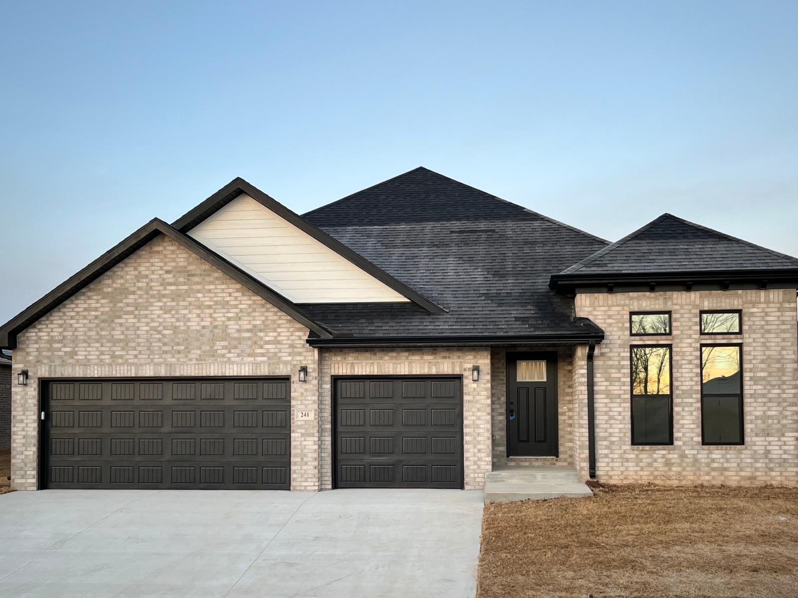 Contemporary home with light gray Triangle Brick Smokey River brick and black trim