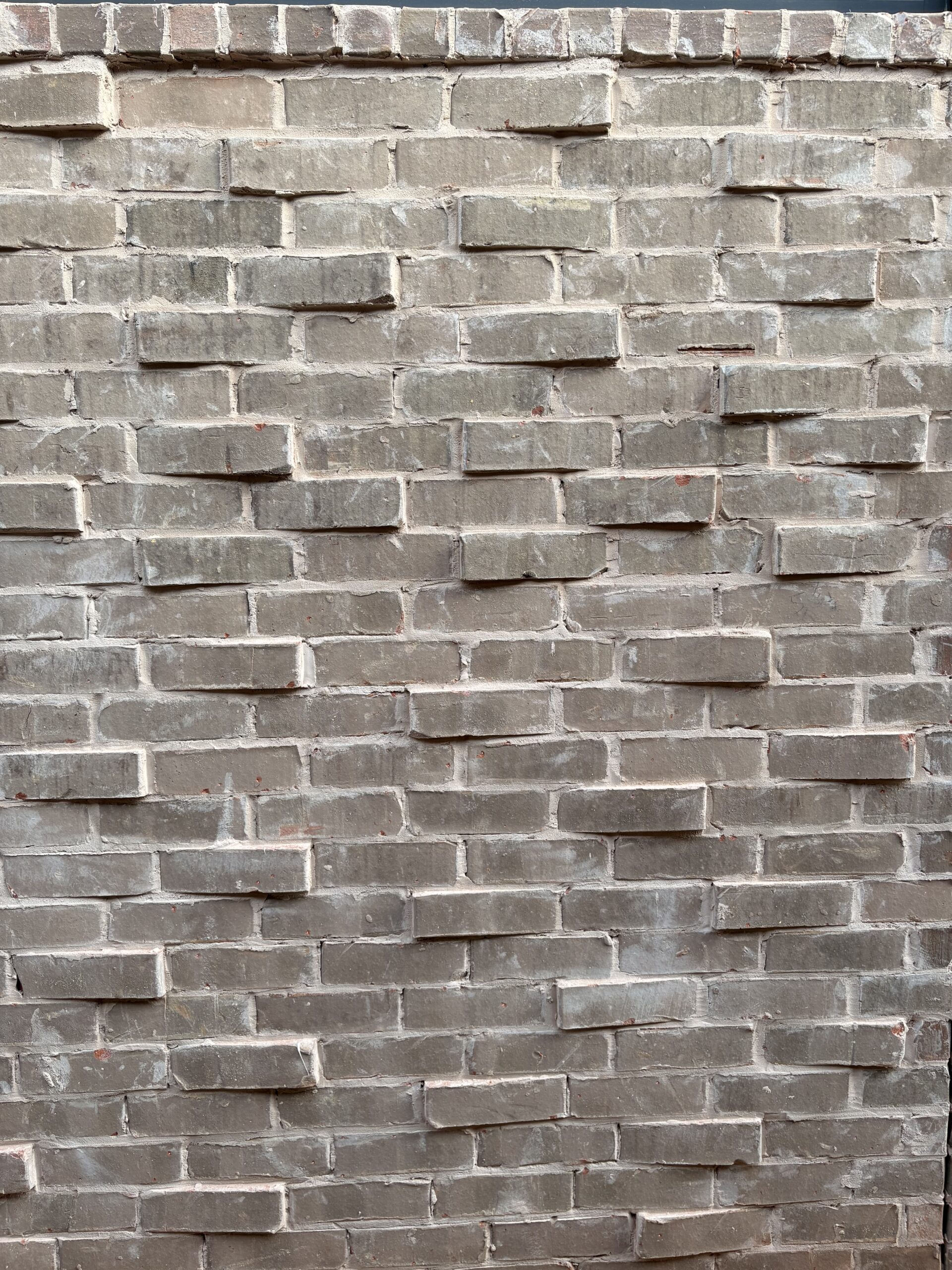 Close view of Greystone brick faces and mortar joints