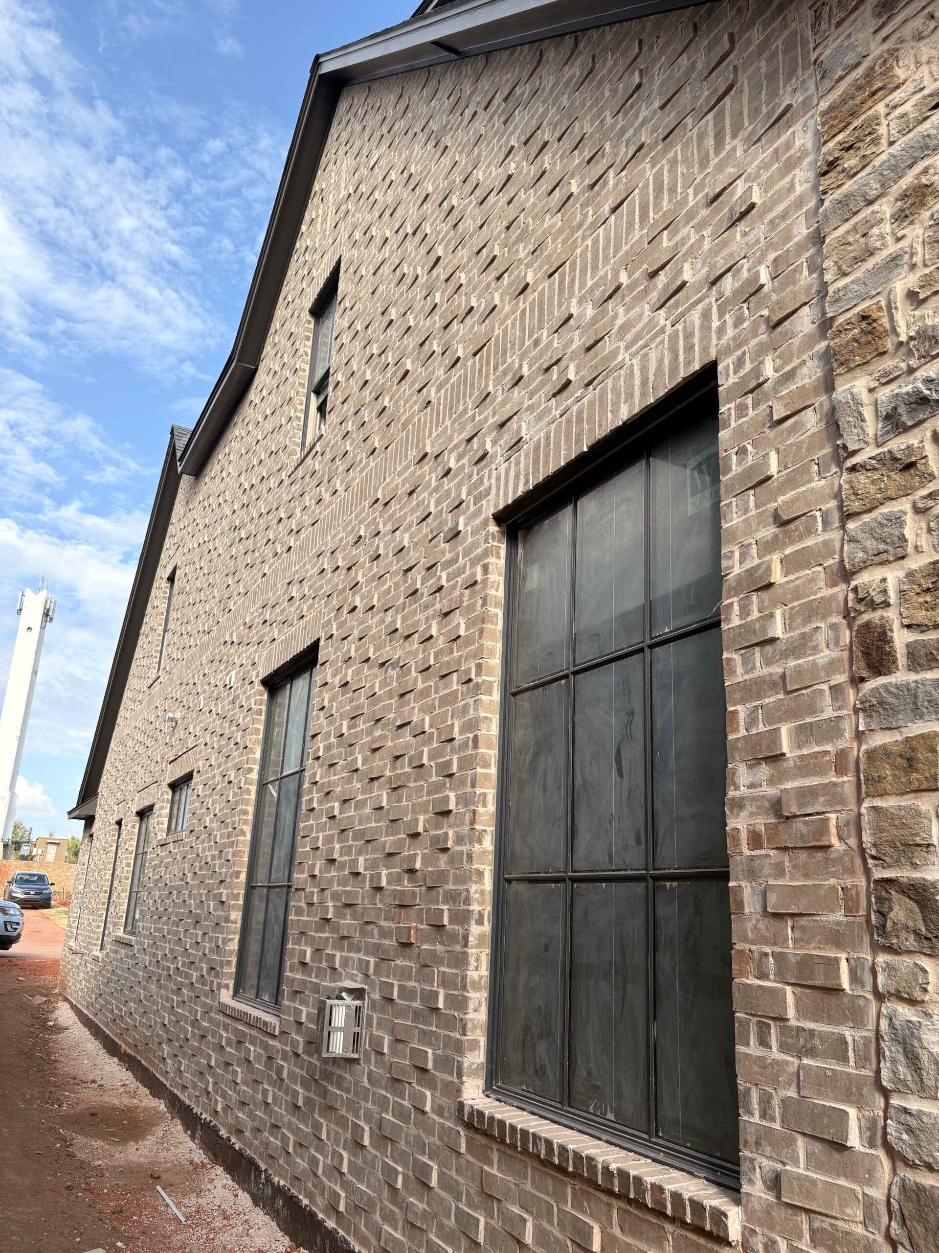 Angled view of Greystone brick alongside dark window frames