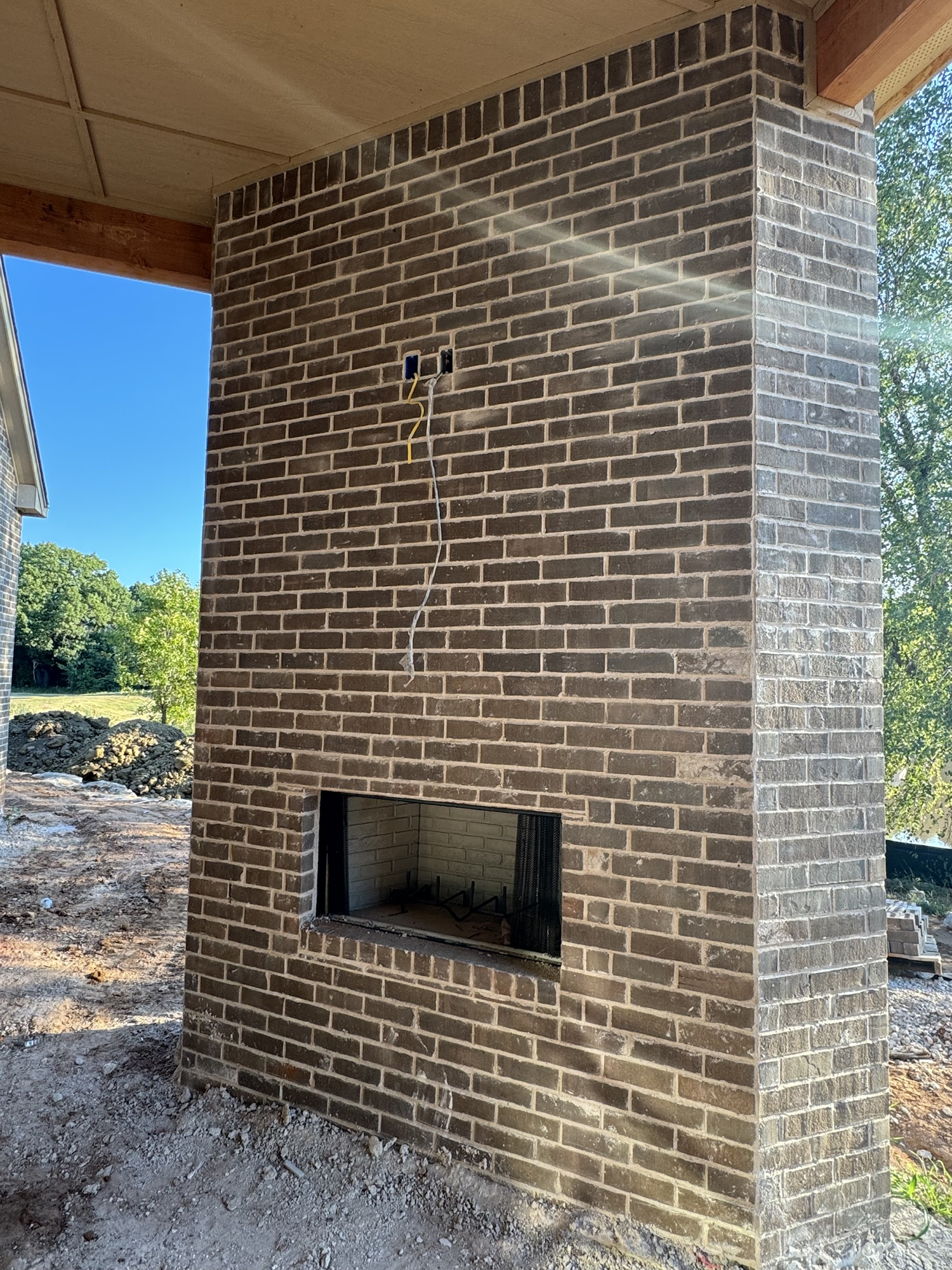 Covered outdoor fireplace and brick detail
